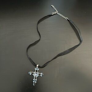 Silver cross necklace with blue and black gemstones